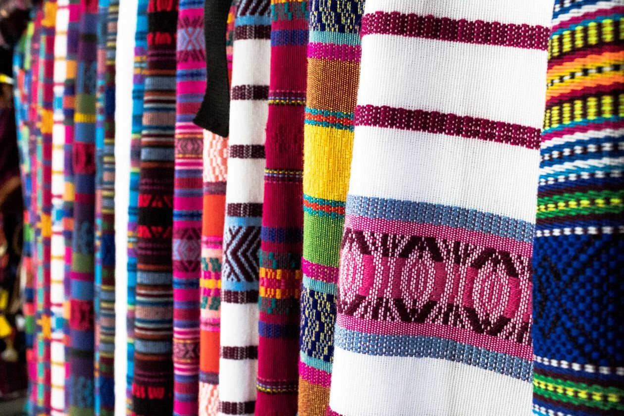Colorful woven Guatemalan textiles with traditional patterns at a highland market